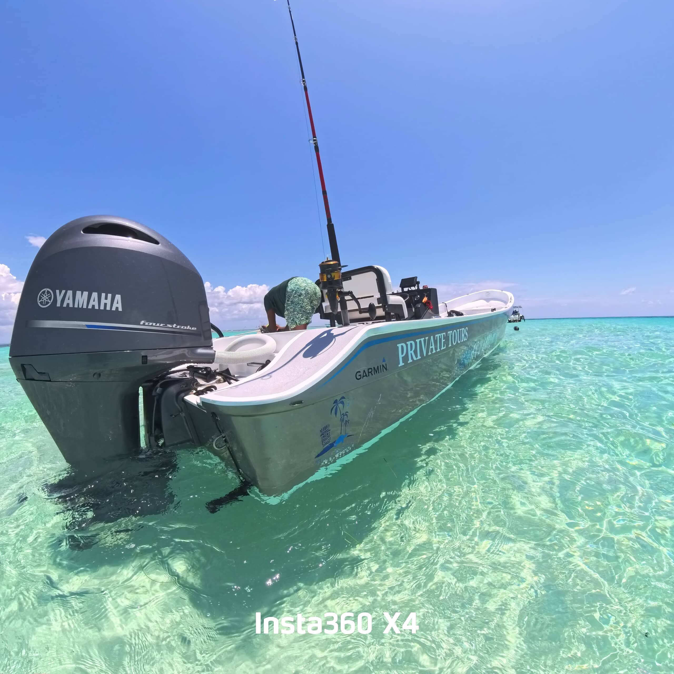 Handsome Tiki boat anchored in clear turquoise waters. Perfect for private tours and exploring Roatan's beaches.