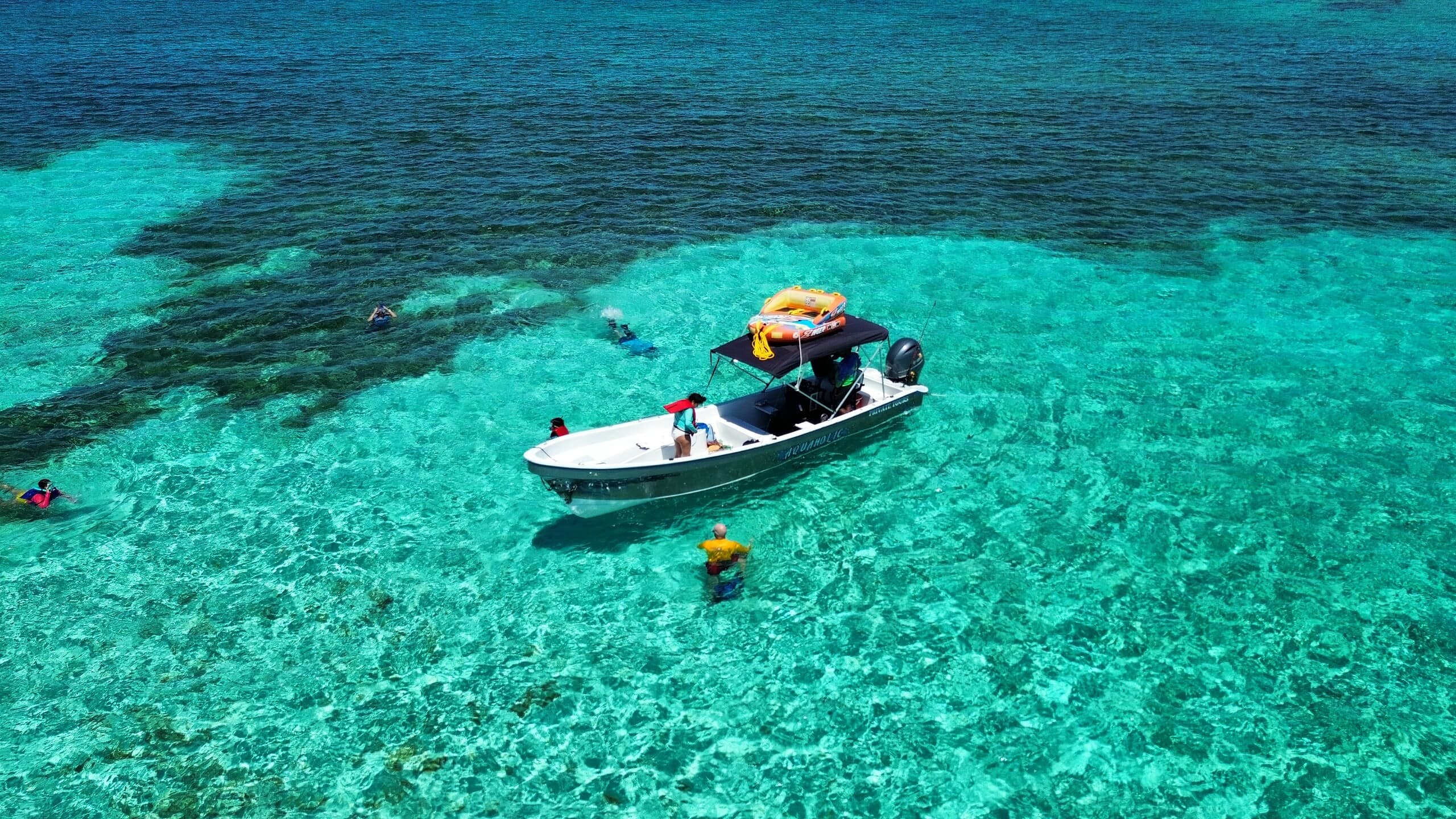 A scenic Tiki Boat in Roatan offering snorkeling excursions in crystal-clear waters, perfect for marine exploration.